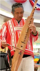  ??  ?? INDIGENOUS tribal icon Rogelio “Waway” Saway plays an ethnic musical instrument during the program.