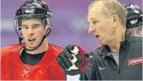  ?? AL CHAREST/CALGARY SUN ?? Team Canada coaching consultant Ralph Krueger speaks with Sidney Crosby during a practice at the 2014 Olympic Winter Games in Sochi, Russia, on Feb. 11, 2014.