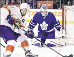  ?? FRANK GUNN / AP ?? Maple Leafs goalie Curtis McElhinney doesn’t give up much for the Panthers’ Aleksander Barkov to shoot at in Tuesday’s game in Toronto.