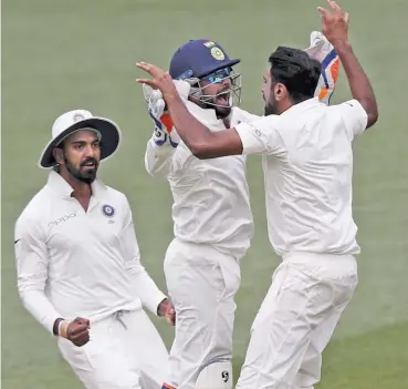  ?? — AP ?? KL Rahul, Rishabh Pant and R. Ashwin celebrate Australia’s final wicket in the first Test at Adelaide on Monday.