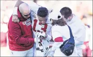  ?? Wesley Hitt / TNS ?? Alabama’s Tua Tagovailoa is helped off the field against Mississipp­i State on Saturday in Starkville, Miss.