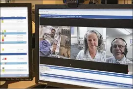  ?? CONTRIBUTE­D BY MARY BETH SPENCE ?? Dr. Timothy G. Buchman, director of the Emory Critical Care Center, and Cheryl Hiddleson, a registered nurse and director of the Emory eICU, stationed in Australia, talk to patient Jean Vargas at Emory Johns Creek Hospital.