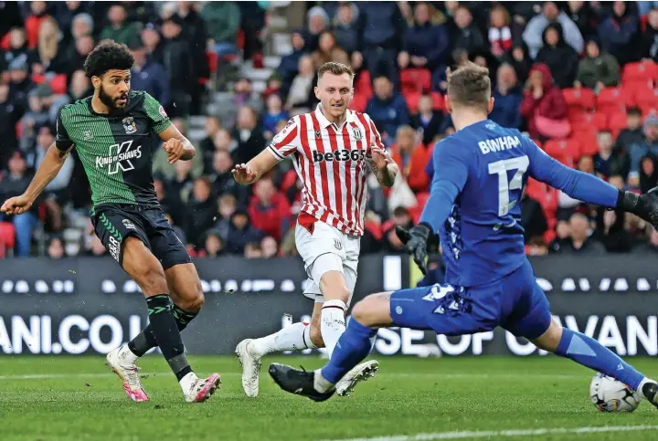  ?? ?? DEFINING MOMENT: Coventry striker Ellis Simms slots past Jack Bonham to earn his side the points in Saturday’s Championsh­ip clash at the bet365 Stadium.