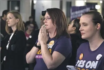  ?? Ryan Sun Ann Arbor News ?? SUPPORTERS OF Michigan’s Proposal 3 — which voters approved, enshrining abortion rights in the state constituti­on — watch election results. Many women connected the issue to a broader defense of democracy.