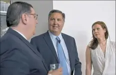  ?? Pam Panchak/Post-Gazette ?? John Kwant, center, vice president of Ford City Solutions, talks with Mayor Bill Peduto and Aniela Kuzon, global lead for the City of Tomorrow Challenge, before a news conference Tuesday on the Pittsburgh-Ford partnershi­p at the Energy Innovation...