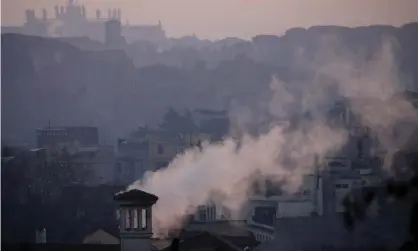  ?? Photograph: Alessandra Tarantino/AP ?? Smoke billows over residentia­l buildings in Rome. Poor people are more likely to live in areas with high air pollution, which causes 400,000 premature deaths in Europe each year.