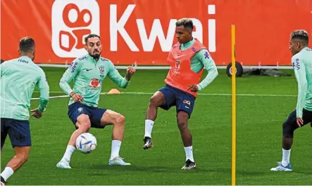  ?? — AFP ?? Hard at work: (From left) brazil’s ribeiro, alex Telles, strikers rodrygo and raphinha attend a training session at the Continassa training ground in Turin, Italy, on monday.