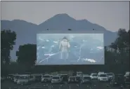  ?? JAE C. HONG — ASSOCIATED PRESS FILE ?? Moviegoers watch a movie preview at Mission Tiki drive-in theater in Montclair, Calif., on May 28, 2020.