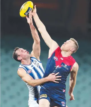 ?? Picture: SARAH REED ?? WILLING CONTEST: North Melbourne's Todd Goldstein and Melbourne's Tom McDonald battle it out in the ruck in the Demons’ convincing win at Adelaide Oval.