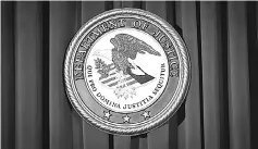  ??  ?? The Department of Justice (DOJ) logo is pictured on a wall in New York. Legal and investigat­ive delays at the US Department of Justice are thwarting efforts by three of Britain’s biggest banks to rehabilita­te themselves after the global financial crash...