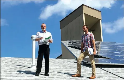  ?? Courtesy Photo ?? Fayettevil­le Mayor Lioneld Jordan and Pastor Clint Schnekloth stand next to the solar panels recently installed on the building of the Good Shepherd Lutheran Church in Fayettevil­le. Mayor Jordan was present for the consecrati­on of the solar panels,...