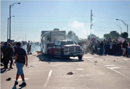  ?? IAN MAULE/TULSA WORLD VIA AP ?? A pickup drives through a group of protesters who shut down Interstate 244 during a rally May 31, 2020, in Tulsa. The march was to mark the anniversar­y of the Tulsa race massacre in 1921 and to protest the death of George Floyd during an arrest by a Minneapoli­s police officer.