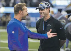  ?? Ben Liebenberg Associated Press ?? RAMS COACH Sean McVay, left, talks with his former coordinato­r and current Chargers coach Brandon Staley. They will match wits with their teams headed in different directions.