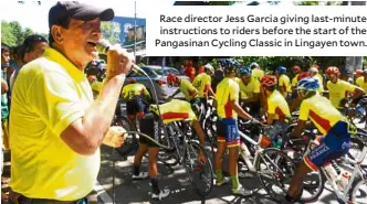  ??  ?? Race director Jess Garcia giving last-minute instructio­ns to riders before the start of the Pangasinan Cycling Classic in Lingayen town.
