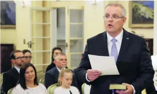  ?? PHOTO: REUTERS ?? Out with the old . . . New Australian Prime Minister Scott Morrison attends a swearingin ceremony as his wife Jenny looks on, in Canberra, last Friday.