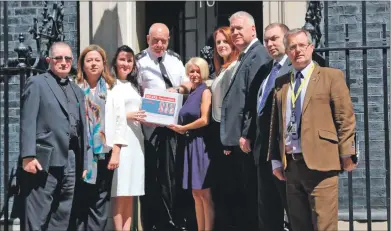  ?? Photograph courtesy of Yvonne MacHugh. ?? Yvonne MacHugh, in white dress, with family members and MP Brendan O’Hara, far right, as they deliver the petition to the Prime Minister in Downing Street.