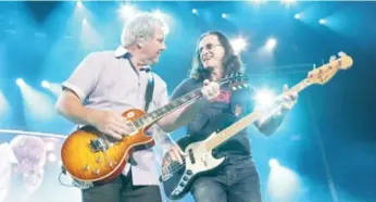  ?? ANDREW MACNAUGHTA­N ?? Rush members Alex Lifeson, left, and Geddy Lee, who both grew up in Willowdale, perform in 2011.