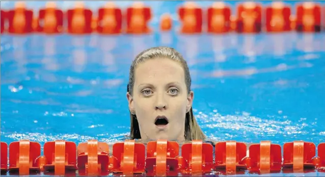  ?? CHRISTINNE MUSCHI / REUTERS FILES ?? Annamay Pierse reacts after the women’s 200m breaststro­ke heats in Shanghai last year. A mosquito bite in India in 2010 resulted in a severe case of dengue fever that cut short her swimming career.