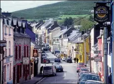  ?? Rick Steves’ Europe ?? Pub signs dot the facades of Dingle’s main drag.