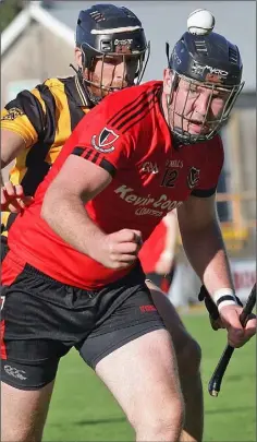  ??  ?? Peter Murphy of Oulart-The Ballagh follows the flight of the ball with Aidan Cash (Shelmalier­s) hot on his heels.