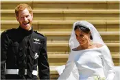  ?? BEN BIRCHALL / WPA POOL / GETTY IMAGES ?? Prince Harry and Meghan Markle come out on the steps by the west door of St. George’s Chapel on Saturday after being married.