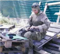  ??  ?? Okuyeva cleans her machine gun in a military training camp not far from Kiev in this 2014 file photo.