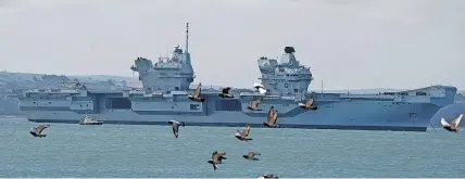  ?? Pictures: PA ?? > Aircraft carrier HMS Prince of Wales sits off the coast of Gosport, Hampshire, after it suffered a propeller shaft malfunctio­n. Below, HMS Queen Elizabeth is likely to stand in for its sister ship