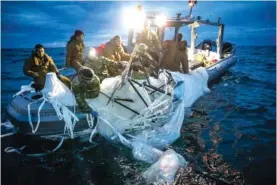  ?? U.S. NAVY VIA AP ?? Sailors assigned to Explosive Ordnance Disposal Group 2 recover a high-altitude surveillan­ce balloon Sunday off the coast of Myrtle Beach, S.C.