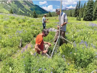  ?? COURTESY OF LOS ALAMOS NATIONAL LABORATORY ?? The ARM team sets up instrument­s in Crested Butte this summer to collect data on how climate is affecting snowpack and water availabili­ty.