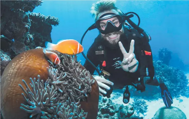  ?? Picture: SOTA YAMAGUCHI ?? UNCERTAIN FUTURE: Passions of Paradise dive instructor Jake Stefani on Flynn Reef. The Great Barrier Reef’s long-term viability is now “very poor”.