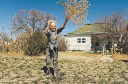  ??  ?? AliceWebb, 97, tosses tumbleweed­s from her front yard in Karval onMonday. Lincoln County and much of the Eastern Plains have been hit hard by the current drought. RJ Sangosti, The Denver Post