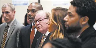  ?? BRIAN CASSELLA/CHICAGO TRIBUNE ?? Special prosecutor Dan Webb, center, looks on as Jussie Smollett, right, appears for a hearing where his case was assigned to a judge Feb. 24 at the Leighton Criminal Courts Building.
