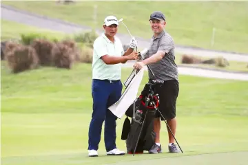  ??  ?? In this handout file photo released by PGA TOUR Series-China on Oct 10, Chinese golfer Yuan ‘Carl’ Yechun (left) takes a club from his caddy during the Pro-Am of the Clearwater Bay Open golf tournament in Hong Kong. — AFP photo