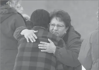  ?? CP PHOTO ?? Family and supporters hug outside court as a judge decides if a teen who pleaded guilty in the 2016 La Loche, Sask., shooting spree that left four people dead and seven others wounded will be sentenced as an adult.