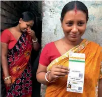  ?? Reuters ?? Maumita Das, a resident of Panchanant­ala slum with her Aadhar card, a government-issued identity card, in Kolkata city. —