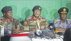  ?? TSVANGIRAY­I MUKWAZHI / ASSOCIATED PRESS ?? Zimbabwe Army Gen. Constantin­o Chiwenga (center) addresses the media Monday in Harare. The country’s generals have been involved in talks with President Robert Mugabe on a way out of the leadership crisis.