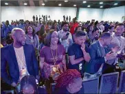  ?? HYOSUB SHIN / HYOSUB.SHIN@AJC.COM ?? Members of the audience react as U.S. Sen. Cory Booker speaks Friday at the Young Leaders Conference. Booker used the occasion to urge church leaders to take a more active stance in the 2020 elections “or we will never make it to the promised land.”