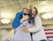  ?? Chip Somodevill­a Getty Images ?? ELIZABETH WARREN hugs grandchild­ren Atticus and Lavinia before addressing her supporters.