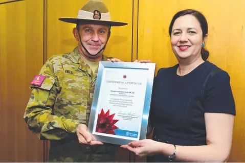  ?? WELL DONE: Brigadier Chris Field accepts an award from Premier Annastacia Palaszczuk. ??