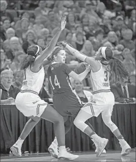  ??  ?? MARIA LIDDANE of American feels defensive pressure from UCLA’s Michaela Onyenwere, left, and Jordin Canada during the first half.