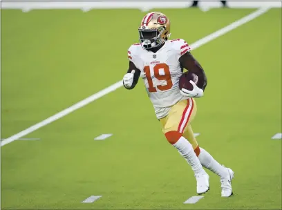  ?? PHOTOS BY JOE SCARNICI — GETTY IMAGES ?? San Francisco 49ers wide receiver Deebo Samuel runs with the ball during the second half against the Los Angeles Rams at SoFi Stadium on Sunday in Inglewood.