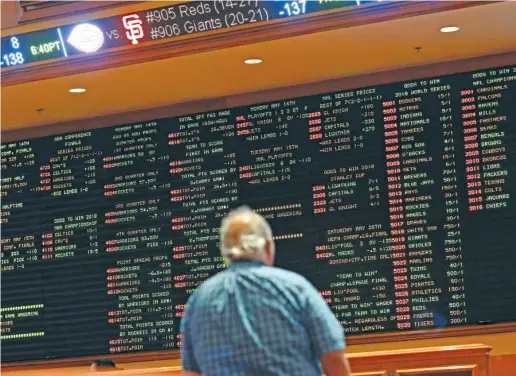  ?? JOHN LOCHER/AP ?? Betting odds are displayed on a board in the sportsbook at the South Point hotel and casino in Las Vegas.