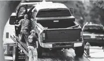  ?? Carolyn Kaster / Associated Press ?? Authoritie­s tow a pickup after its driver surrendere­d Thursday, hours after claiming to have a bomb near the Capitol.