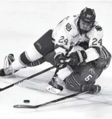  ??  ?? Denver’s Colin Staub and Ohio State’s Tommy Parran battle for the puck in October at Magness Arena. John Leyba, Denver Post file