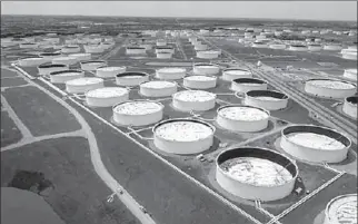  ?? OKLAHOMA
-AP ?? Crude oil storage tanks are seen in an aerial photograph at the Cushing oil hub in Cushing, Oklahoma, U.S.