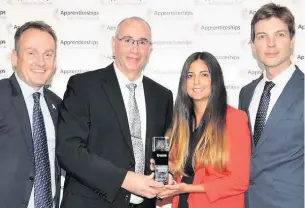  ??  ?? ●●Andy Turner and Toni Carter (middle) receiving their award for Macro Employer of the Year