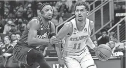  ?? DALE ZANINE/USA TODAY SPORTS ?? Hawks guard Trae Young drives against Suns forward Josh Okogie during the first half on Thursday at State Farm Arena in Atlanta.