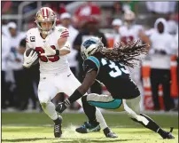  ?? EZRA SHAW/GETTY IMAGES/TNS ?? George Kittle (85) of the San Francisco 49ers is tackled by Tre Boston (33) of the Carolina Panthers on Sunday in Santa Clara.