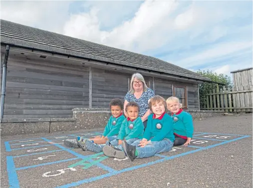  ?? Photograph by Robert MacDonald ?? BUSINESS AS USUAL: Scallywags Nursery manager Karen Williamson with four of her five pupils. From left: brothers William and James Page, William Macdonald and Ellie Fogarty-MacDonald.