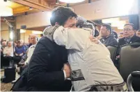  ??  ?? People gather to hear Prime Minister Justin Trudeau deliver an official apology for Ottawa’s management of tuberculos­is in the Arctic from the 1940s to the 1960s in Iqaluit, Nunavut, on Friday. Left, Trudeau is greeted by an Inuit elder before the event.